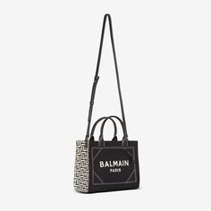 Join the style ranks of Balmain with the B-Army tote bag – hailing from a collection that draws on the House’s military influences. The roomy silhouette is crafted from canvas and trimmed with leather, framing the esteemed Balmain logo embroidered front and center that’s sure to command attention. Backpack Travel Bag, Mini Wallet, See By Chloe, Wallet Bag, Phone Bag, Monogram Canvas, Logo Embroidered, Fashion Handbags, Crossbody Shoulder Bag