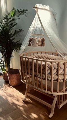 a baby crib in the middle of a room with a teddy bear on it