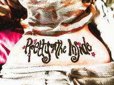 the back of a person's stomach with writing on it that says pretty to the inside