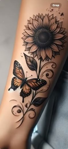 a woman's leg with a sunflower and butterfly tattoo design on the side