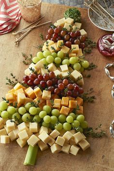 a christmas tree made out of cheese and grapes