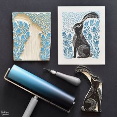 three different types of art work are displayed on a black surface with blue ink and paper