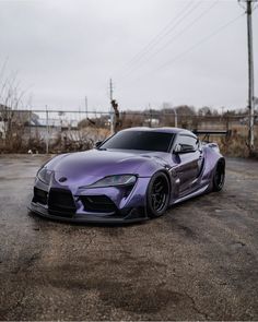 a purple sports car parked in a parking lot