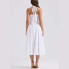 Embrace timeless beauty with this stunning A-line fit and flare midi dress. The halter neck provides a classic yet contemporary look, ideal for any fashionable wardrobe. Delicately crafted with pleated sides on the skirt, this dress combines elegance with a playful twist. Whether you’re attending a garden party, a cocktail event, or a dinner date, this dress is your go-to for effortless style and grace. Color: White, Pink, FloralSilhouette: Fit & FlareLength: MidiMaterial: PolyesterNeckline: Hal Chic A-line Tea Length Dress With Pleated Bodice, Fitted A-line Halter Sundress, A-line Midi Dress With Pleated Bodice For Date Night, Chic A-line Midi Dress With Pleated Skirt, Summer A-line Midi Dress With Pleated Skirt, Classic A-line Midi Dress For Date Night, Chic A-line Tea Length Summer Dress, Elegant Summer A-line Halter Dress, Classic Sleeveless Midi Dress For Summer