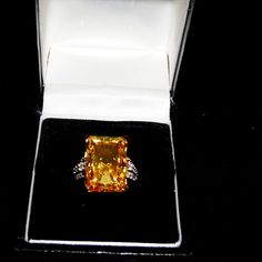 4.00ct Rectangular Octagonal Citrine Simulant Ring With 0.09ctw Round White Zircon Details At Sides. Solitaire Style. Prong Faceted. 18k Yellow Gold Over Sterling Silver. Size 7. Measures Approximately 3/4" Long And 1/2" Wide. Finished Under Gallery. New With Tags. Luxury Yellow Topaz Ring With Diamond Accents, Yellow Diamond Ring With Yellow Sapphire Gemstone, Yellow Sapphire Diamond Ring With Gemstone, Formal Yellow Topaz Ring With Diamond Accents, Octagon Topaz Ring With Diamond For Formal Occasions, Fine Jewelry Yellow Diamond Gemstones, Yellow Diamond Baguette Cut Jewelry, Gold Sapphire Ring With Radiant Cut For Formal Occasions, Gold Radiant Cut Sapphire Ring For Formal Events