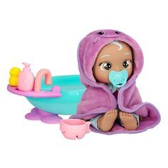 a baby doll sitting in a bathtub with toys