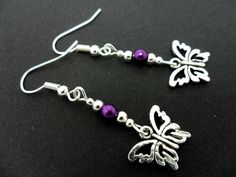 This a pair of pretty tibetan silver dangly butterfly earrings. Measure approx. 4cm from top of hook to bottom of earring. Freshly made by me and unworn. Thanks for looking!! Nickel-free Adjustable Butterfly Earrings, Handmade Metal Butterfly Earrings, Silver Butterfly Charm Drop Earrings, Handmade Butterfly Metal Earrings, Purple Dangle Jewelry With Butterfly Charm, Adjustable Drop Earrings With Butterfly Charm, Silver Drop Earrings With Butterfly Charm, Adjustable Purple Metal Earrings, Purple Metal Earrings