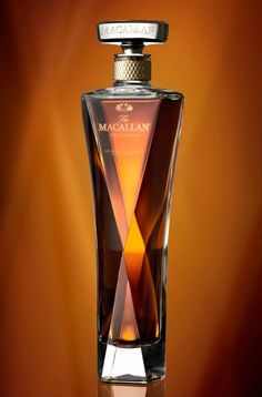 a bottle of macallan is shown on a brown and orange background in this image