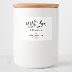 a white canister with a wooden lid