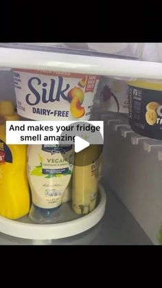 an open refrigerator with milk, yogurt and other items on the shelf in it