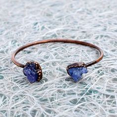 GemFormingStudio D E T A I L S Tanzanite Bangle | Adjustable Bangle | Bangle For Her | Bangle For Women | Gift For Her | Gift For Women | Gemstone Bangle [GFS2855] Stone Size: 12x11 mm Weight: 10.86 gm Bangle Size: 3 inches Color: purple Material: Copper Polish: Copper Antique Plated . Contact us for wholesale prices. R I N G S https://www.etsy.com/in-en/shop/GemFormingStudio?section_id=22783374 B E A D S https://www.etsy.com/in-en/shop/GemFormingStudio?section_id=22828835 W A N D S https://www. Adjustable Sapphire Jewelry With Natural Stones, Adjustable Sapphire Bracelet Jewelry, Adjustable Sapphire Crystal Bracelet, Adjustable Sapphire Crystal Bracelet Gift, Adjustable Blue Gemstone Cuff Bracelet, Adjustable Blue Cuff Bracelet With Natural Stones, Gemstone Bangle Bracelets, How To Polish Copper, Adjustable Bangle Bracelet