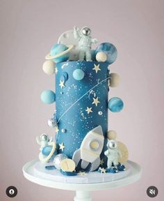 a blue cake with stars and planets on it