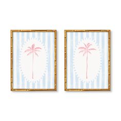 two framed pictures with palm trees on blue and white striped wallpaper, one in gold frame