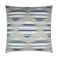 a gray and blue pillow with an abstract design on the front, along with a white background