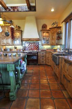 a large kitchen with wooden cabinets and tile flooring