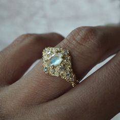 Step into a realm of ethereal beauty with our enchanting "Moonstone Moon Diamond" ring. This ring features a magical natural moonstone with a blue sheen when light reflects on it. Handcrafted in your choice of 14K and 18K gold. Only one available. All orders come in our Tippy Taste ring box. This ring is handmade and designed in NYC. 14K or 18K solid gold Natural oval moonstone. 6*4mm 12 Natural round diamonds. SI clarity, GH color, 0.11ct total carat weight 1.1mm width, 1.5mm thick band ** Tippy Taste Heirloom Collection is made to order. Please allow 3-4 week turnaround time. Shipping:Domestic: Free shippingInternational: Free shippingAll orders are insured, come with tracking, and with signature requirements. Please review our international shipping. Customization:- Interested in custom Celestial Moonstone Ring With Rose Cut Diamonds, Mystical Moonstone Ring For Anniversary, Ethereal Moonstone Gemstone Ring, Unique Gold Moonstone Ring With Rose Cut Diamonds, Mystical Moonstone Ring For Wedding, Mystical Moonstone Moon-shaped Ring For Wedding, Mystical Moon Shaped Moonstone Wedding Ring, Ethereal Moonstone Crystal Ring For Wedding, Mystical Moon-shaped Moonstone Wedding Ring