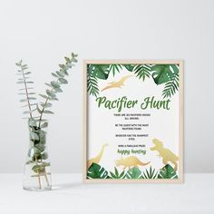 there is a vase with some plants in it next to a framed poster that says pacificr hunt