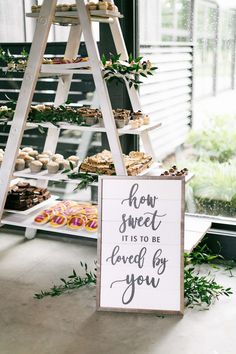 a sign that says how sweet it is to be loved by you on a ladder