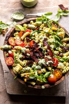 a bowl filled with pasta and vegetables on top of a table