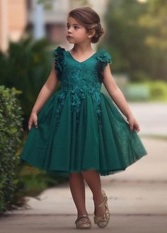 Fit for a princess, this dress has it all. Soft emerald satin graced with a touch of lace, this dress is a showstopper! Sleeves are embellished with whimsical die cut flowers that will have all eyes on her. Tulling overlay skirt adds just the right touch of fullness and twirl. Fully lined with soft cotton, back zip. 100% poly self, 100% cotton lining. Machine wash, hang dry. Flowergirls Dress, Green Toddler Dress, Trish Scully, Teal Green Dress, Girl Green Dress, Dress For Baby Girl, Long Flower Girl Dresses, Bianca Dress, Emerald Green Dress