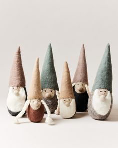 five gnomes are lined up in different colors