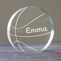 a clear glass trophy with the name emma on it and a basketball in the center