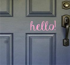 a door with the word hello painted on it and an open front door handle in pink