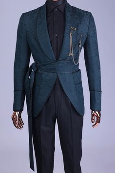 a mannequin dressed in a blue suit with chains on it's lapel