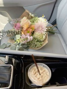 a bouquet of flowers sitting on top of a table in the back seat of a car