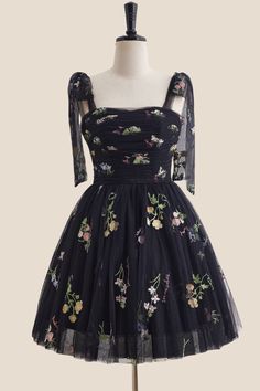 Enjoy your night out in this playful black floral dress. With an A-line silhouette and corset bodice, this dress is sure to hug your curves in all the right places. The tie shoulders and lace-up back add both style and comfort, allowing you to dance the night away. Plus, with built-in bra for support and above knee length, this dress is both flattering and easy to wear. 

SKU: OM1148
Tulle material 

Black color

A-line silhouette
Corset bodice with tie shoulder and floral

Ruched details
Built-