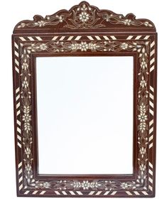 an ornate wooden mirror with white and brown trimmings on the edges, against a white background