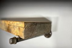 a close up of a wooden shelf on a wall