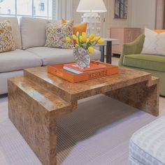 a living room filled with furniture and a coffee table