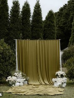 an outdoor ceremony setup with white flowers and greenery