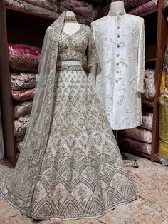 a mannequin is standing next to a dress and jacket on display in a store