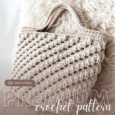 a crocheted bag sitting on top of a fluffy white blanket with the words, premium crochet pattern