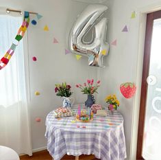 a birthday party with balloons and decorations on the wall, including an inflatable number six balloon