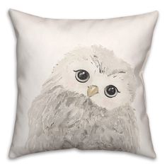 a white pillow with an owl painted on it's face and eyes, sitting in front of a white background