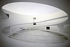 a circular room with white walls and floors