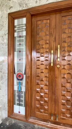 a wooden door with decorative glass on it