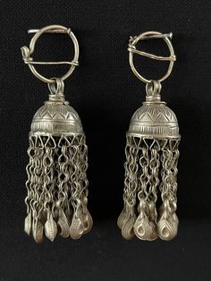 Antique pair of Afghanistan Tribal Silver Ceremonial Earrings with Silver Tassels. Size - Height : 7.5 cm x Circumference : 7 cm x Weight : 25 gr. Free Shipping. Antic Silver Earrings, Luxury Traditional German Silver Earrings, Traditional Silver Earrings With Bells, Traditional Silver Bell Earrings, Traditional Dangle Clip-on Earrings, Silver Dangle Earrings With Bells, Traditional Dangle Clip-on Earrings With Latkans, Ornate Earrings For Rituals, Traditional Earrings With Bells