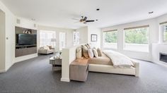 a large living room with couches and a flat screen tv