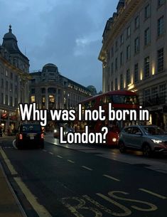 the words why was i not born in london? are displayed on a city street