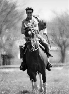 a man riding on the back of a brown horse