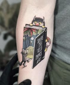 a person with a tattoo on their arm holding a book that says, there are two things