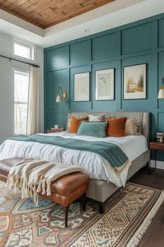 a bedroom with teal walls and white bedding in the center, along with a large rug on the floor