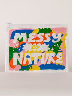 a small bag with the words messy and nature printed on it in multicolors