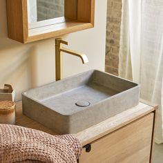 a bathroom sink sitting on top of a wooden counter