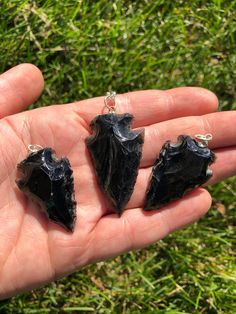 This listing is for a single (1) beautiful Black Obsidian Arrowhead Pendant.  You can choose to purchase the pendant only or add a chain of your desired length from the drop-down.  Please note that these are stock photos of a few of the Arrowhead Pendants that we have available. These are natural Crystals & Gemstones and each pendant will have variation in natural characteristics such as Size, Shape, and Color. Size ~ 1" - 1.5"  Known as a powerful cleanser and best stone for protection, our Bla Black Obsidian Pendant Jewelry, Handmade Black Arrowhead Jewelry, Handmade Black Arrowhead Necklace, Black Onyx Healing Jewelry, Black Onyx Jewelry For Healing, Obsidian Pendant With Natural Stones, Black Obsidian Gemstone Jewelry, Crystal Necklace Black, Black Obsidian Necklace