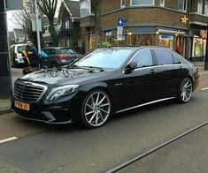 a black car is parked on the street